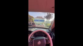 Driver cuts a square hole in car's windscreen tint film to see clearly
