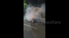 China: Tricycle paper load caught fire while passing through a street in China