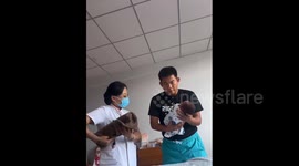 China: Chinese new father nervously held his newborn baby for the first time