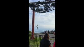 Man rides a zipline upside down in front of a crowd in Tagaytay, Philippines