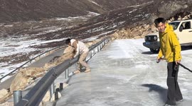 Travelers struggle to keep balance on an icy mountain pass in Yunnan, China
