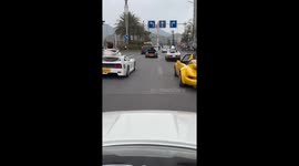 Friends parade their mini toy cars across road in China