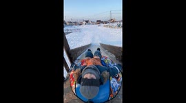 Kid Stumbles Off The Sledding Ramp