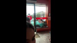 Electric taxi car crashes into restaurant in Indonesia