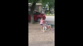 Hammer mishap startles young girl while playing with bicycle in Premont, Texas, USA
