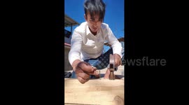 China: Chinese man demonstrates practice-built precision by striking only the middle nail