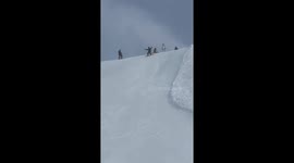 Snowboarder loses balance while descending a snowy hill in Zhejiang, China