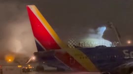 Planes de-iced during freezing winter weather at airport in New York