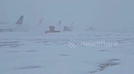 Tractors battle heavy snow at airport in Canada