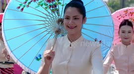 Thai Beauty Contestants Riding Bicycles While Holding Umbrellas in Bo Sang, Chiang Mai