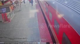 Passenger with child slips while boarding moving train, quick-thinking officials pull them to safety