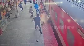Passenger with child slips while boarding moving train, quick-thinking officials pull them to safety
