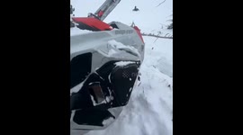 Sled slips away during retrieval on a steep snowy hill in West Yellowstone, Montana, USA