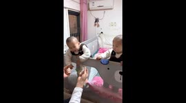 Amusing moment identical twins mirror each other’s every move