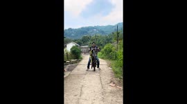 Rider practicing wheelie stunt lose control of motorcycle and accelerates on roadside