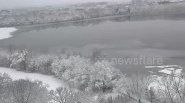 Quiet winter snowfall blankets Fresh Pond in Cambridge, USA