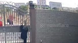 China: Elderly Chinese grandma scales tall gate after rusted door gets stuck