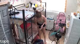 Cheeky pet cat whacks owner on the head as she tidies bedroom