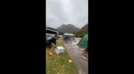 Hapless campers watch on as flash flood washes away cars, tents, and belongings in Australia