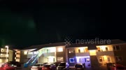 Aurora borealis shimmers over the night sky in Reykjavík, Iceland