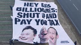 Giant banner urging billionaires  Elon Musk and Jeff Bezos to 