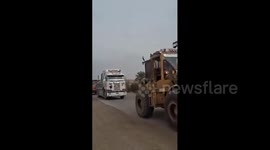 Syria: Heavy machinery and trucks belonging to the people of Dhiyaban town participate in the rehabilitation operation of the bridge in Al-Ushara town in the eastern countryside of Deir ez-Zur