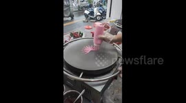 China: Chinese vendor creates pink floral jianbing with decorative molds