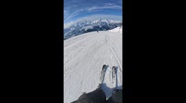 Skier takes a tumble after small jump on snowy slope in Québec, Canada
