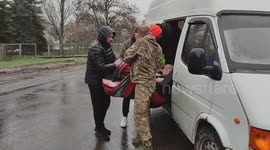 Emotional Rescue in the Rain: Volunteers evacuate bedridden senior on a blanket near Vuhledar, Ukraine