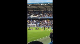 The atmosphere reaches fever pitch at Stamford Bridge as Chelsea and Arsenal Women walk out of the tunnel for their high-stakes London derby. Filmed from the Arsenal supporters' section, the footage captures the roar of the crowd, the pre-match pyrotechni