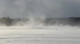 Rare snow rollers form in strong winds at Black Creek in Chili, New York, USA