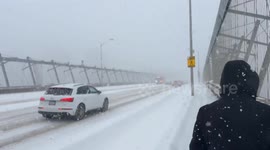 Emergency responders from Toronto Fire Services drive fire trucks across the Prince Edward Viaduct (Bloor–Danforth Viaduct) during a major winter snowstorm in Toronto, Canada on January 25, 2026. Heavy snowfall from a polar vortex blankets the bridge and 