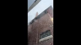 Cinematic slow-motion footage of heavy snow falling during a major winter snowstorm in Toronto, Canada on January 25, 2026, as thick snowfall from a polar vortex blankets the city in whiteout conditions.