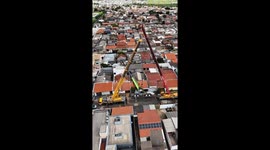 Truck-mounted crane topples over onto homes in Brazil