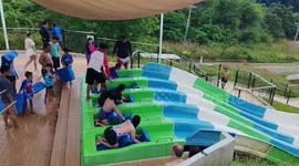 Tourists fail to move and need a push down water slide