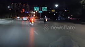 China: Chinese motorcyclist thrown off after riding up onto sidewalk curb