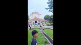 Woman accidentally falls into a ditch while carrying street food