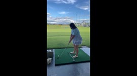 Woman tries golf for the first time only to make a feeble attempt at shot
