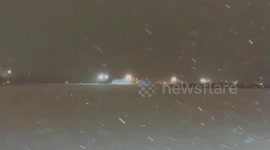 Snow cleared from runway at Dulles airport during snowstorm