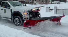 Snowplow clears heavy snow during winter storm in Berks, Pennsylvania, USA