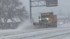 Snowplows clear roads during winter storm in Buffalo, New York, USA