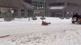 Jeep Tows Sledders Through Snowy Philadelphia Streets During Major Storm
