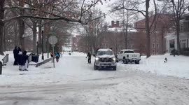 Snowboarder cruises across snow-covered road in Ohio
