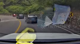 Cars dodge out-of-control lorry on winding mountain road