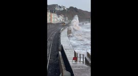 Storm Chandra: Huge waves crash over seawall and over passing trains in Devon