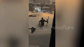 Toronto resident waist-deep in snow after storm batters North America