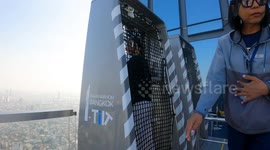 Visitors experience 1,000ft high ride that tilts over the edge of skyscraper