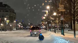 Driver pulls skier along snow-covered road in the US