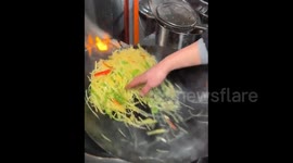 China: Chinese man shows extreme heat tolerance by stir frying with bare hands