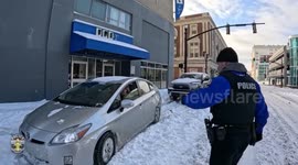 US: Police Battle Deep Snow To Free Trapped Vehicle After Winter Storm